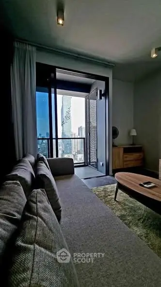 Modern living room with city view and stylish furniture in high-rise apartment.