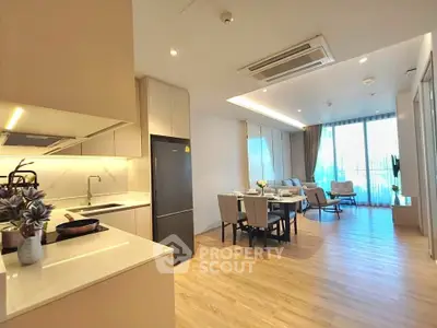 Spacious open-plan kitchen and living area with modern furnishings and natural light.