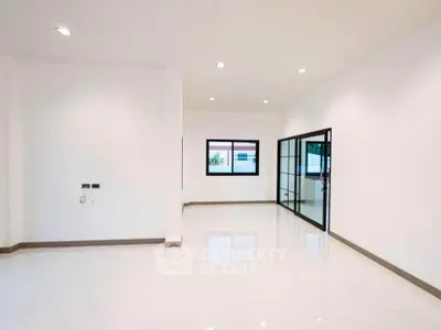 Spacious modern living room with large windows and sleek flooring