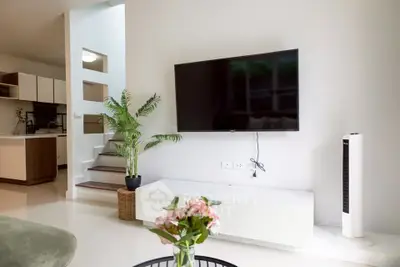 Modern living room with wall-mounted TV and stylish decor