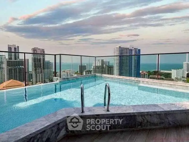 Stunning rooftop pool with panoramic city and ocean views, perfect for luxury living.
