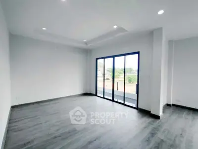 Spacious modern living room with large windows and sleek flooring