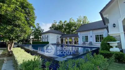 Luxurious villa with stunning pool and lush greenery, perfect for serene living.