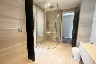 Luxurious modern bathroom with glass shower and elegant wood paneling