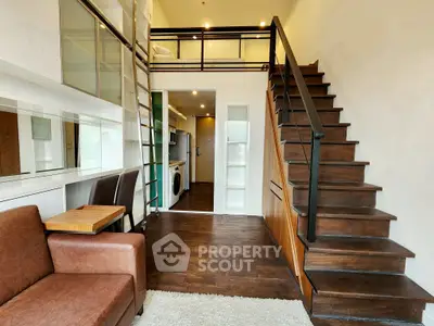 Modern loft apartment with stylish staircase and cozy living area