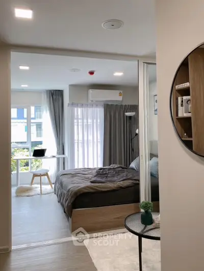 Modern bedroom with large window and stylish decor in a cozy apartment