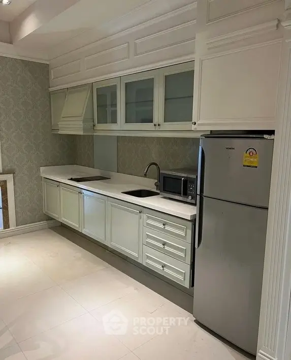 Elegant kitchen with modern appliances and sleek cabinetry in a stylish home.