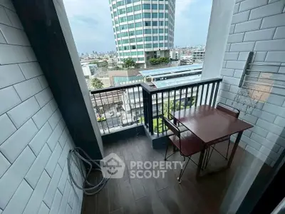 Charming balcony with city view, perfect for relaxation and outdoor dining in urban setting.
