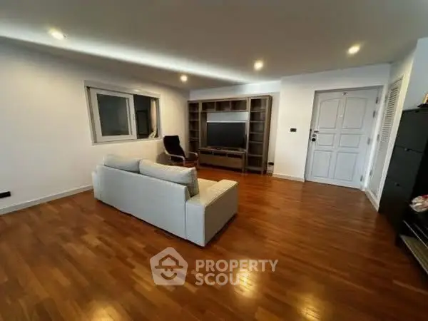 Spacious living room with wooden flooring and modern furniture