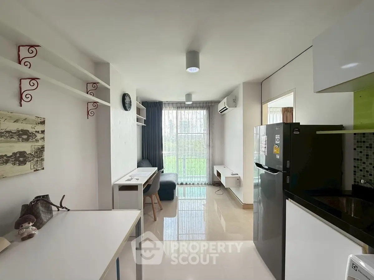 Modern living room with sleek design, featuring a large window and contemporary furniture, perfect for urban living.