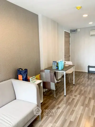 Modern living room with stylish furniture and wooden flooring