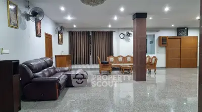 Spacious living room with elegant furniture and polished flooring, perfect for family gatherings.