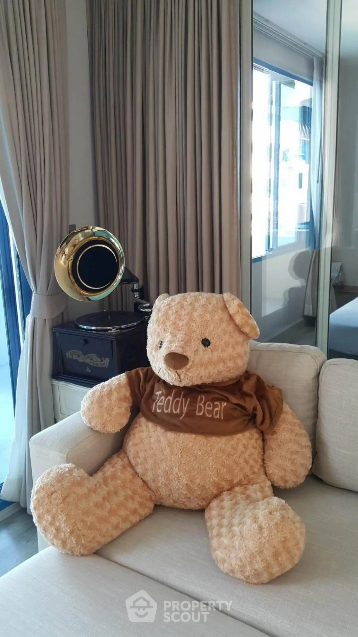 Cozy living room with plush teddy bear and vintage decor