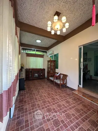 Charming interior with vintage decor and tiled flooring, featuring cozy seating and elegant lighting.