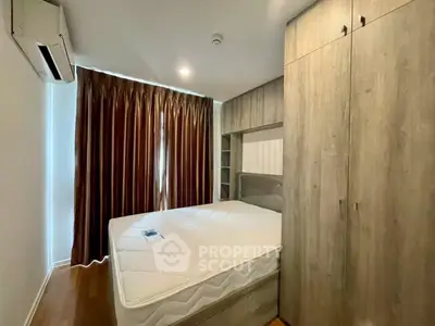 Cozy bedroom with wooden wardrobe and natural light through curtains