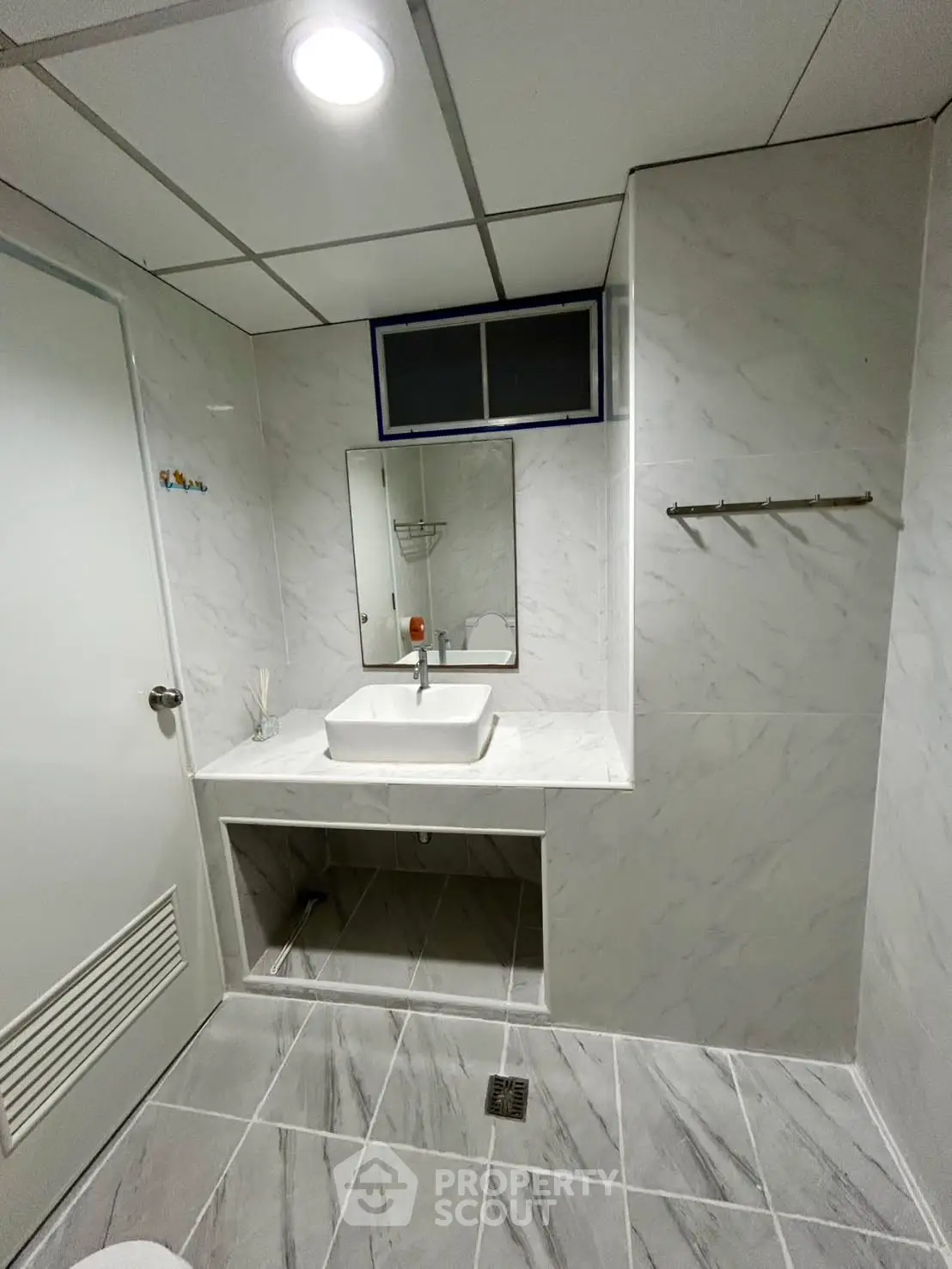 Modern bathroom with marble tiles and sleek sink design