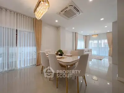 Elegant dining room with modern chandelier and large windows