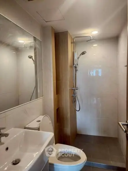 Modern bathroom with sleek shower and elegant fixtures in a contemporary apartment.