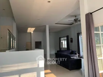 Spacious living room with modern design and ample natural light