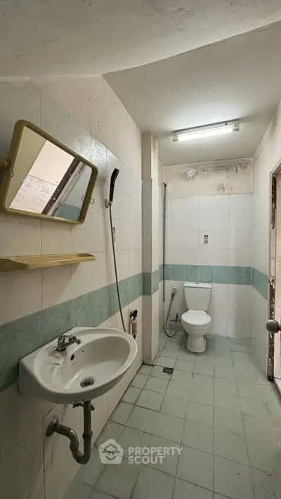 Spacious bathroom with modern fixtures and tiled walls in a real estate property.