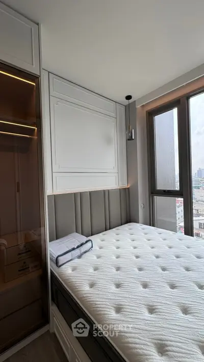 Modern bedroom with large window and stylish decor in urban apartment