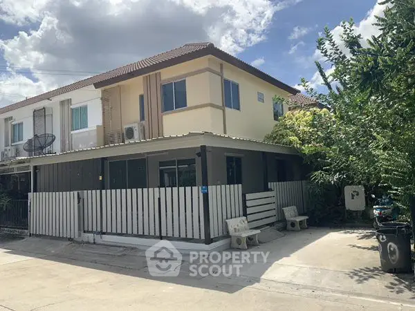 Charming two-story house with modern design and spacious driveway in a serene neighborhood.