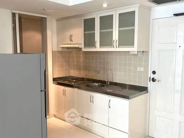 Modern kitchen with sleek cabinets and stainless steel appliances