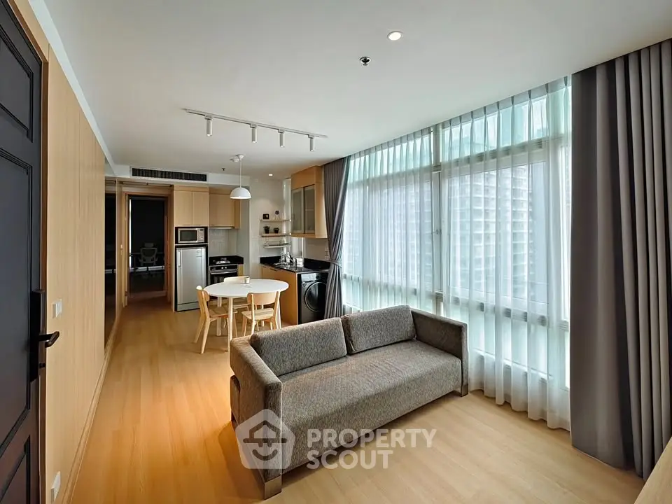 Spacious modern living room with open kitchen and large windows