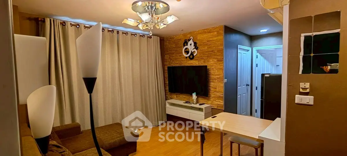 Cozy living room with modern decor and wall-mounted TV, perfect for relaxation and entertainment.