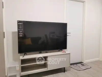 Modern living room with sleek TV and minimalist furniture