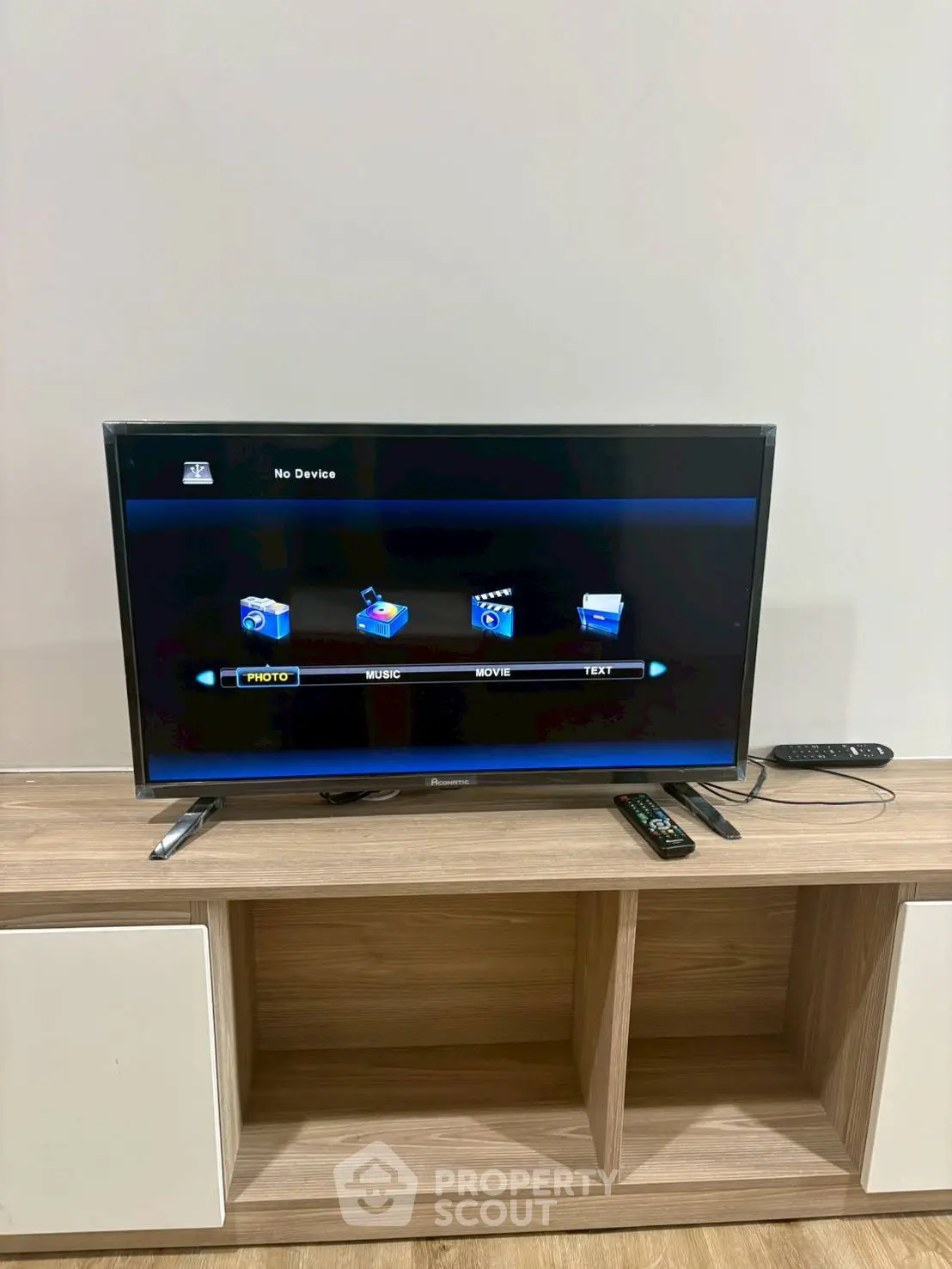 Modern living room with sleek TV unit and wooden storage shelves