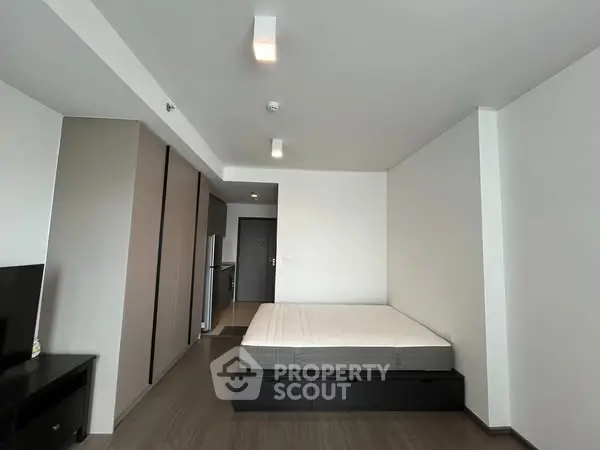 Modern minimalist bedroom with sleek design and ample storage space.