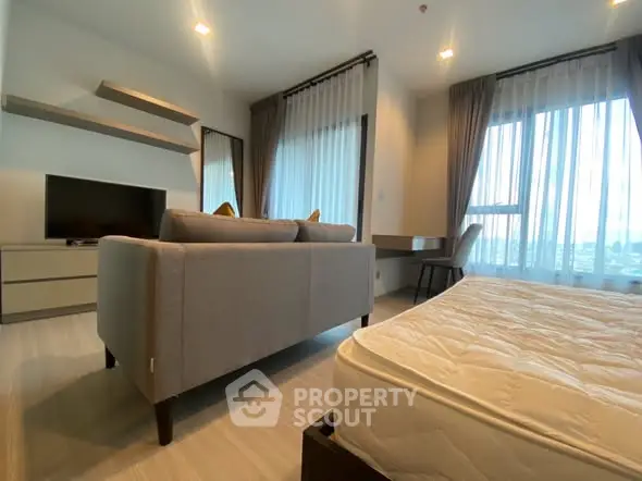 Modern living room with stylish furniture and large windows offering natural light.