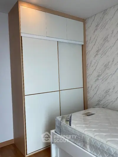 Modern bedroom with sleek wardrobe and comfortable bed