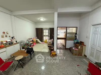 Spacious living room with toys and cozy seating area in a family-friendly home.