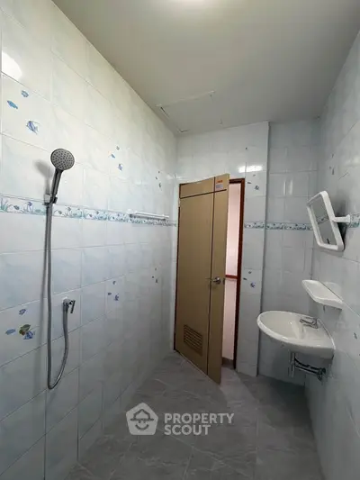 Spacious bathroom with modern shower and sleek tile design