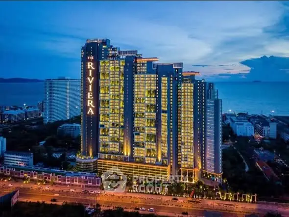 Stunning high-rise building with ocean view at dusk, perfect for luxury living.
