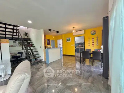 Spacious modern living room with open layout and stylish staircase in a contemporary home.