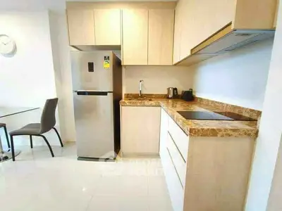 Modern kitchen with sleek appliances and marble countertops in a stylish apartment.