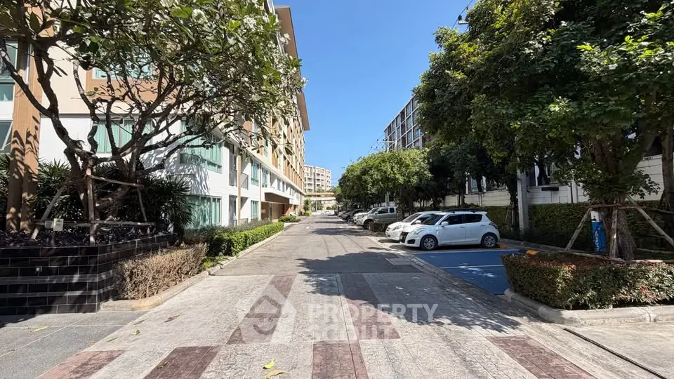 Charming residential street with modern apartments and lush greenery.