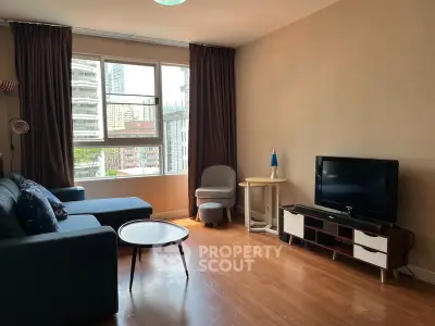 Spacious living room with modern furniture and city view, ideal for urban living.