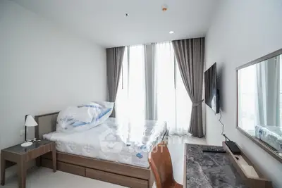 Modern bedroom with large windows and stylish furniture in a high-rise apartment.