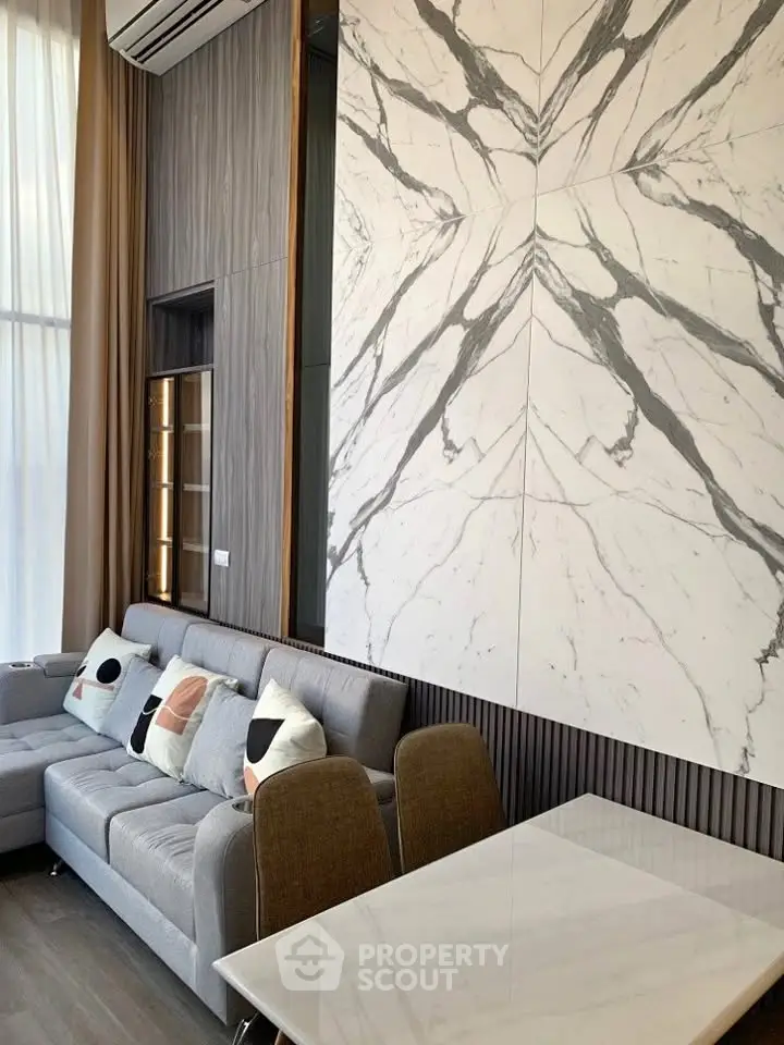 Luxurious modern living room with elegant marble wall and stylish furniture