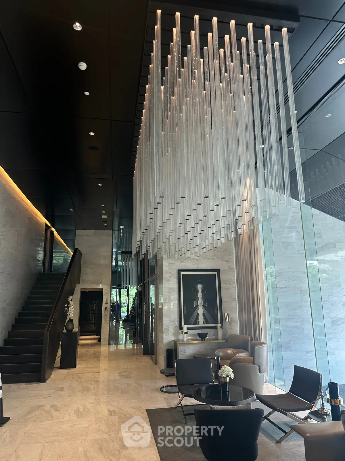 Luxurious modern lobby with stunning chandelier and elegant seating area.