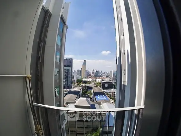 Stunning cityscape view from a high-rise balcony with modern architecture.