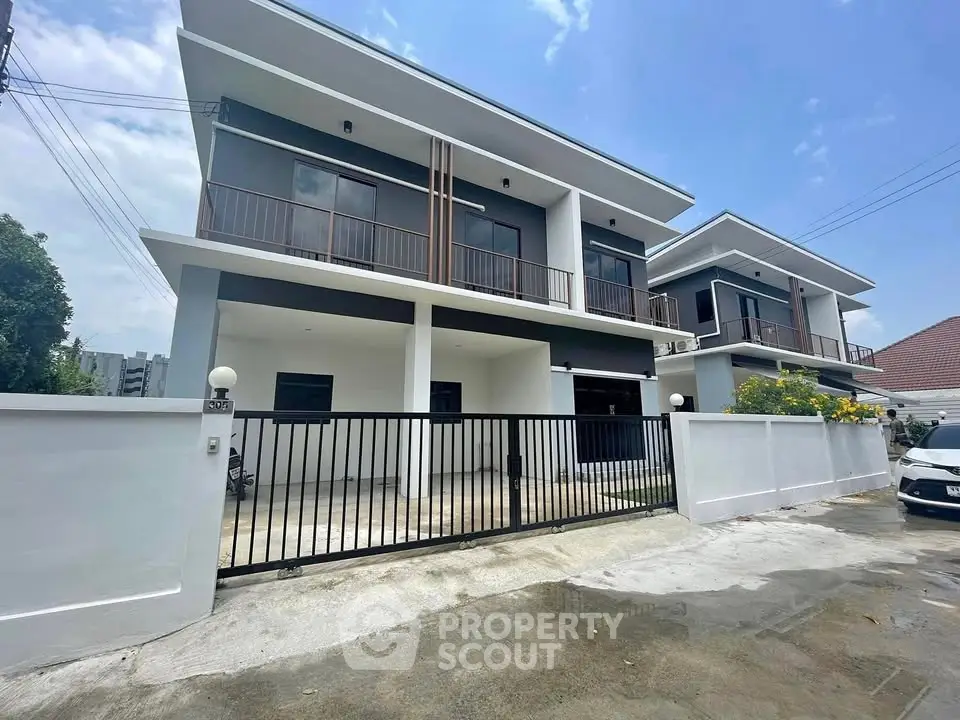 Modern two-story house with sleek design and spacious driveway