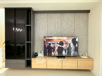 Modern living room with sleek entertainment center and large flat-screen TV