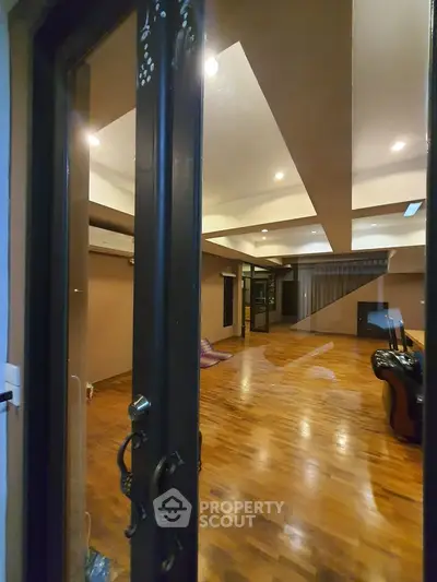 Spacious living room with wooden flooring and modern lighting