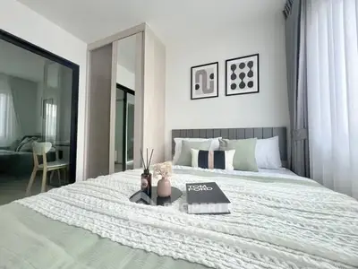 Modern bedroom with stylish decor and cozy bedding in a contemporary apartment.