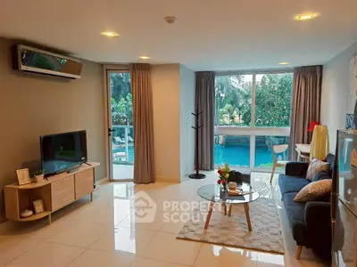 Spacious living room with pool view, modern decor, and natural light.